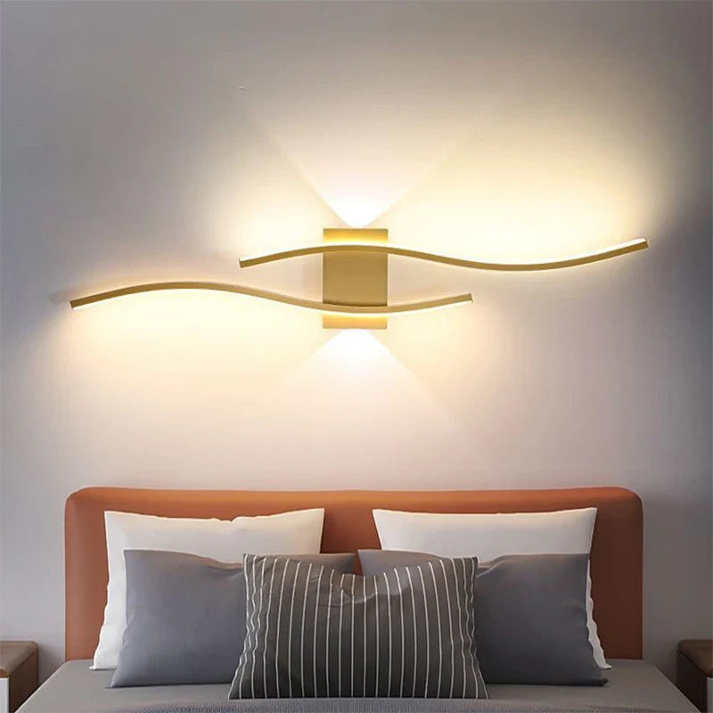 Modern bedroom featuring a brown headboard and gray-striped pillows. The wall is adorned with the Minimalisto Wall Light by XCEPTION, offering warm LED illumination and intelligent control, creating a cozy atmosphere.