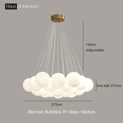 The Blurred Bubbles Chandelier by XCEPTION is a modern lighting fixture featuring 19 frosted glass globes suspended from a gold-finished ceiling mount. This adjustable chandelier measures 150cm in height and 75cm in diameter, with each globe having a diameter of 15cm.