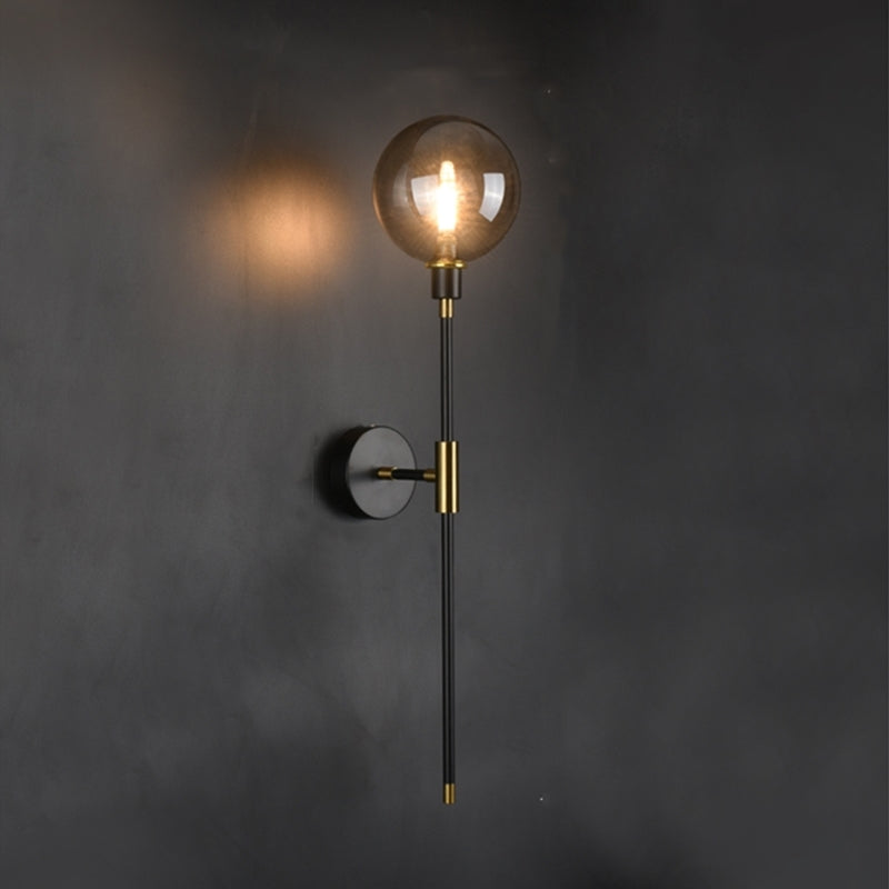 The Scandi Wall Lights by XCEPTION, a perfect example of Scandinavian design, boast a spherical glass shade and a sleek black metal body, perfectly complementing a dark wall. These minimalist sconces are fitted with energy-efficient LED technology, ensuring the light bulb emits a warm glow that cultivates a cozy atmosphere.
