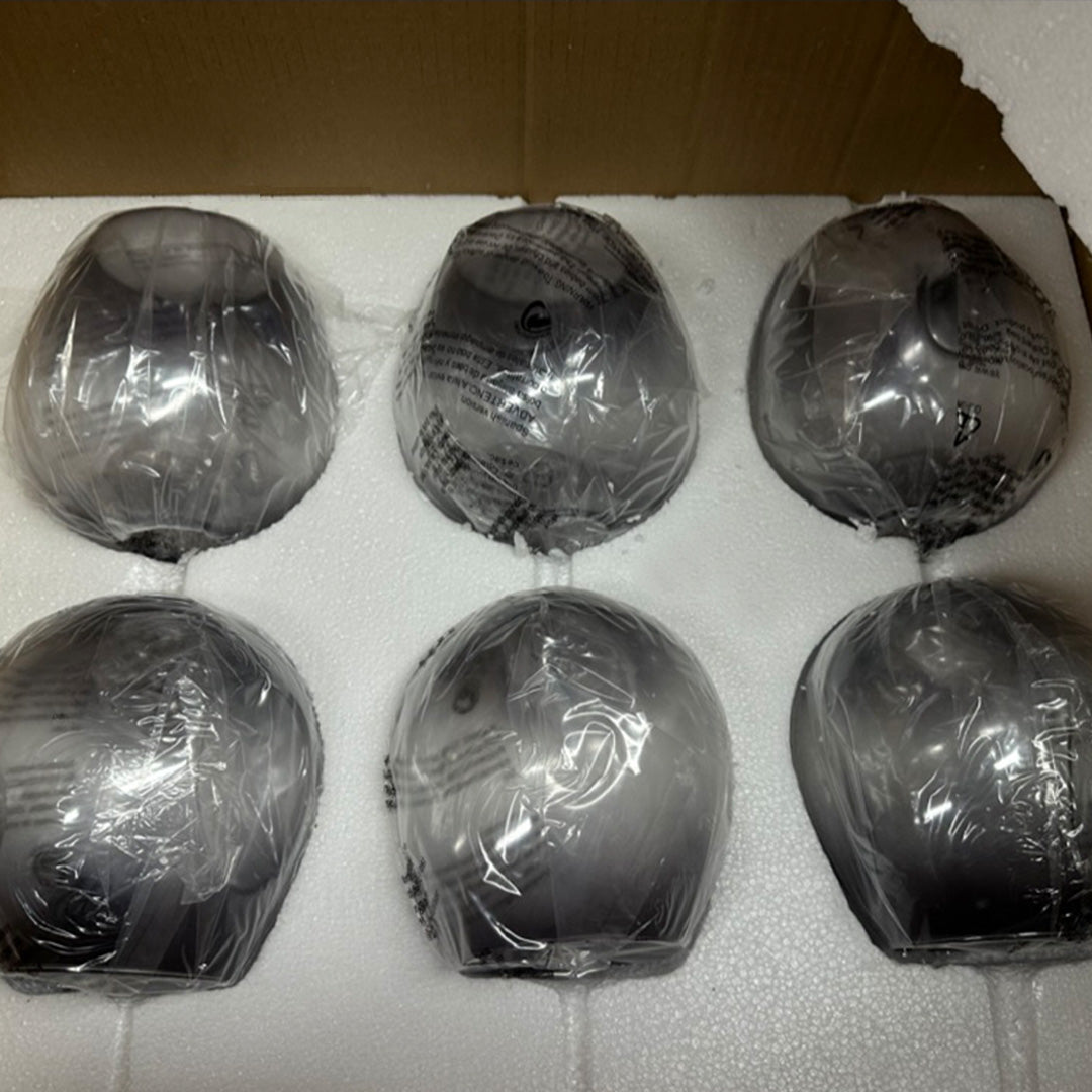 The Retro Loft Ceiling Chandelier by XCEPTION comes packaged with six black spherical objects, each carefully wrapped in clear plastic inside a cardboard box. They are placed on a white foam cushion for protection and separation.