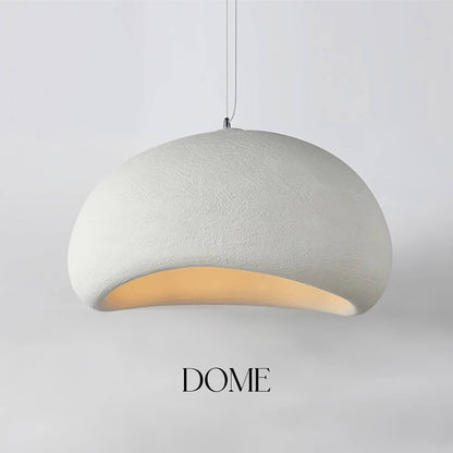 Certainly! Featuring the Organic Cove, an elegantly suspended dome-shaped pendant light in textured white by XCEPTION, this piece creates a stunning focal point. The inner surface glows warmly, accentuating its curved form. Against a plain background, the bold word "Organic Cove" is prominently displayed below, delivering a striking visual centerpiece.