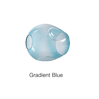 A smooth and reflective translucent glass sculpture with a round, pod-like shape shows off a gradient blue hue, capturing the light beautifully. Below the sculpture on a plain white background is the text Retro Loft Ceiling Chandelier • Black by XCEPTION.